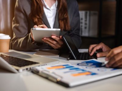 business-people-talking-discussing-with-financial-document-data-charts-graphs-team-business-meeting-with-smart-phone-laptop-digital-tablet-computer